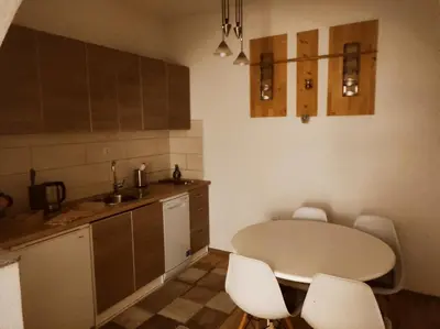 a kitchen with a table and chairs in a room at La Mia Casa in Bihać