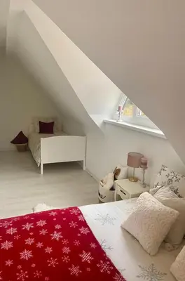 a bedroom with a bed with a red blanket at Farmhouse Dzeni in Vlasic