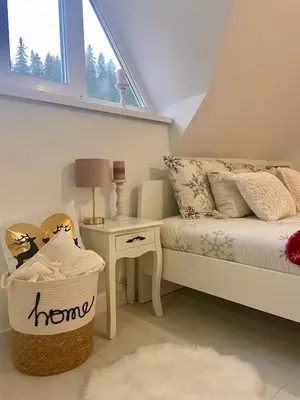 a bedroom with a bed and a table and a window at Farmhouse Dzeni in Vlasic