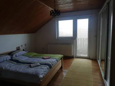 a bedroom with a bed and a large window at Kupres Desktop - mountain house in Kupres