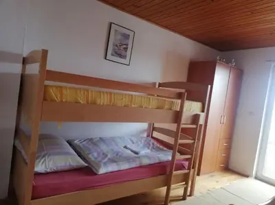 a bunk bed in a small room with a bunk bedutenewayewayangering at Kupres Desktop - mountain house in Kupres