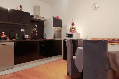 a kitchen with a table and a christmas tree in it at Kupres Desktop - mountain house in Kupres