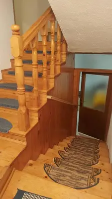 a wooden staircase with a television in a room at Kupres Desktop - mountain house in Kupres