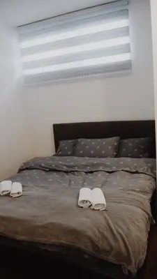 a bed with two white towels on it at Apartman Barbi in Kupres