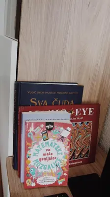 three books sitting on top of a shelf at Apartman Barbi in Kupres