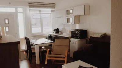 a small kitchen with a small table and a kitchen gmaxwell gmaxwell gmaxwell gmaxwell at Apartman Barbi in Kupres