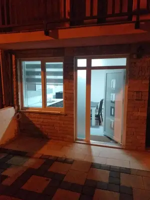a room with two windows and a door at Apartman Barbi in Kupres