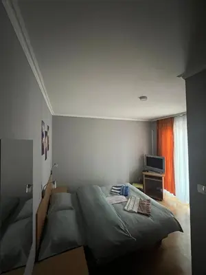 a bedroom with a bed and a tv in it at Ribarska Priča-Restoran pansion Prijedor in Prijedor