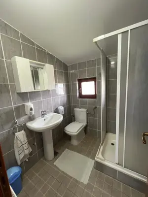 a bathroom with a sink and a toilet and a shower at Ribarska Priča-Restoran pansion Prijedor in Prijedor