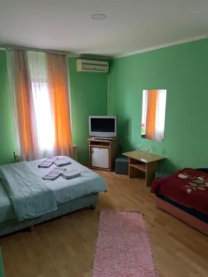 a bedroom with a bed and a television in it at Ribarska Priča-Restoran pansion Prijedor in Prijedor
