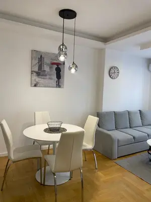 a living room with a couch and a table and chairs at Infinity in Banja Luka