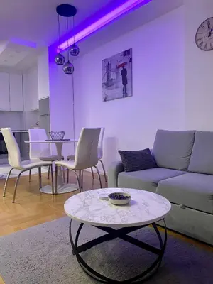 a living room with a couch and chairs and a table at Infinity in Banja Luka