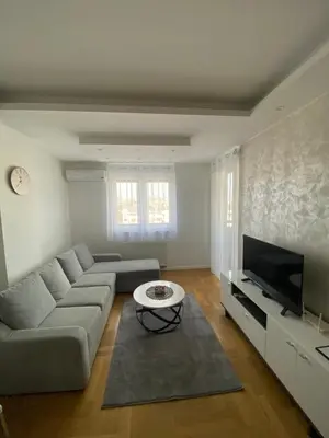 a living room with a couch and a tv at Infinity in Banja Luka