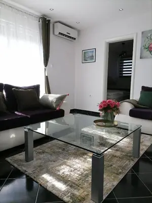 a living room with a glass coffee table at Apartman MN Teslic in Teslić