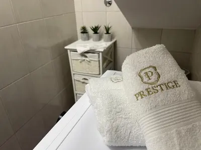 a white pillow sitting on a bed in a bathroom at Apartman MN Teslic in Teslić
