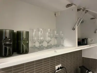 a row of wine glasses sitting on a shelf at Apartman MN Teslic in Teslić