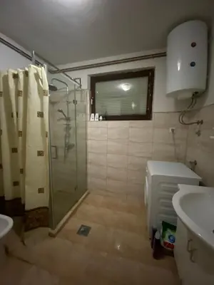 a bathroom with a shower and a toilet and a sink at Apartman De Luxe in Tuzla