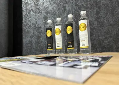 a group of five bottles sitting on top of a table at Apartman De Luxe in Tuzla