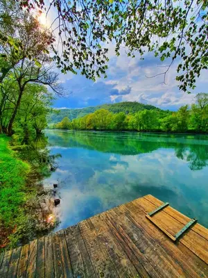 a view of a river with a wooden dock at Vikendica Mimiena in Račić