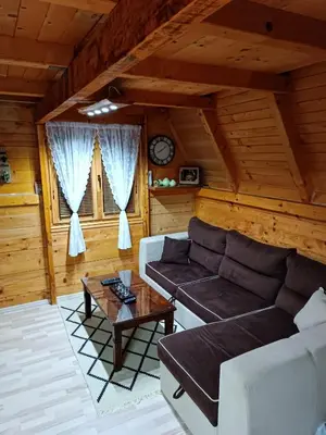 a living room with a couch and a table at Vikendica Mimiena in Račić