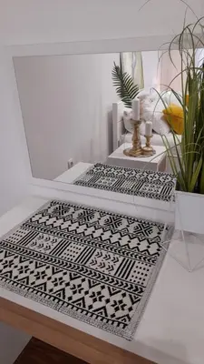 a glass table with a black and white rug at Apartman Jasmina in Bihać