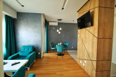a living room with a blue couch and a table at Downtown apartment in Banja Luka
