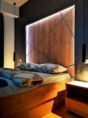 a bed with a wooden headboard in a room at Downtown apartment in Banja Luka