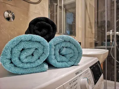 a pile of towels sitting on top of a microwave at Downtown apartment in Banja Luka
