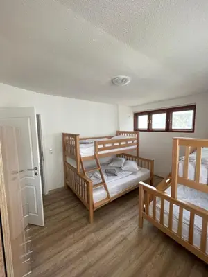 a room with two bunk beds and a door at Planinski raj in Kupres