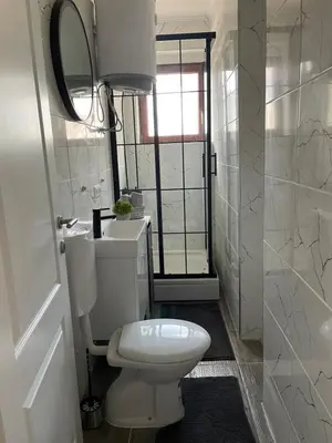 a bathroom with a toilet and a sink and a mirror at Planinski raj in Kupres