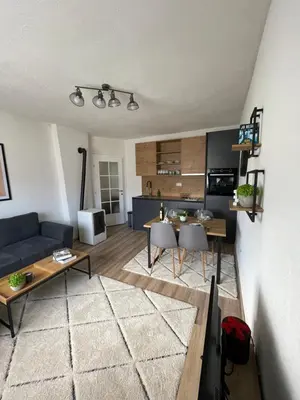 a living room with a couch and a table at Planinski raj in Kupres