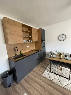 a kitchen with a sink and a table at Planinski raj in Kupres