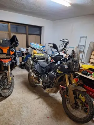 two motorcycles are parked in a garage at Apartman Darko in Kupres