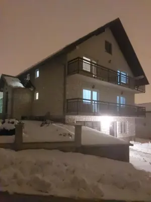 a building with snow in front of it at Apartman Darko in Kupres