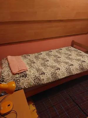 a small bed with a black and white comforter at Vikendica Grganović in Vlasic
