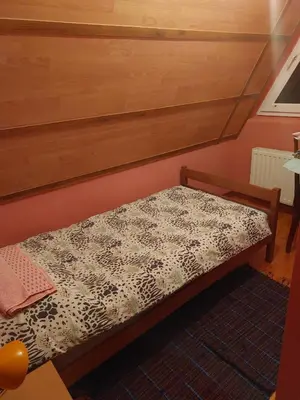 a small bed in a room with at Vikendica Grganović in Vlasic