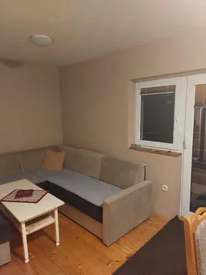 a living room with a couch and a table at Vikendica Grganović in Vlasic