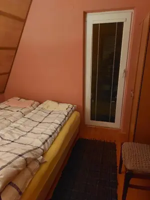 a small bedroom with a bed and a window at Vikendica Grganović in Vlasic