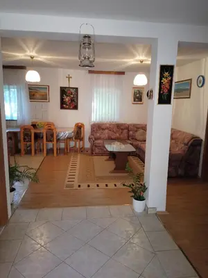 a living room with a couch and a table at Barun apartman in Lusnić
