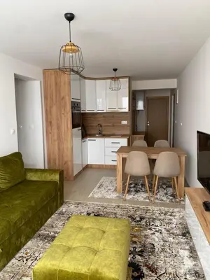a living room with a green couch and a table at Apartman Green in Šišava