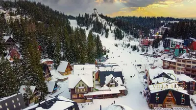 a town covered in snow with a ski slope at Apartman Green in Šišava
