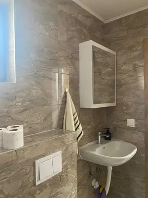a bathroom with a sink and a mirror at Apartman Green in Šišava