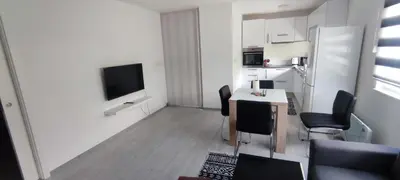 a small kitchen with a table and chairs and a television at Perfect Holidays in Vlasic