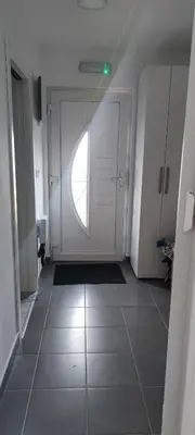 a hallway with a white door and a window at Perfect Holidays in Vlasic