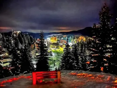 a red bench in front of a city at night at Perfect Holidays in Vlasic
