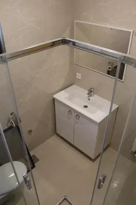 a bathroom with a sink and a mirror and a toilet at LUX Apartmani Vlašićka čarolija in Travnik
