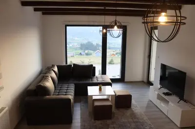 a living room with a couch and a tv at LUX Apartmani Vlašićka čarolija in Travnik