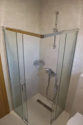 a shower in a bathroom with a glass door at LUX Apartmani Vlašićka čarolija in Travnik