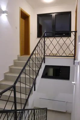 a staircase leading to the second floor of a house at LUX Apartmani Vlašićka čarolija in Travnik