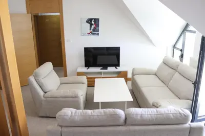 a living room with a couch and two chairs and a tv at Apartmani Vlašić-Petrol in Travnik